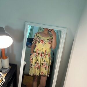 Short yellow dress with flowers on it